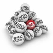Repeat and New Customer words on balls in a stacked